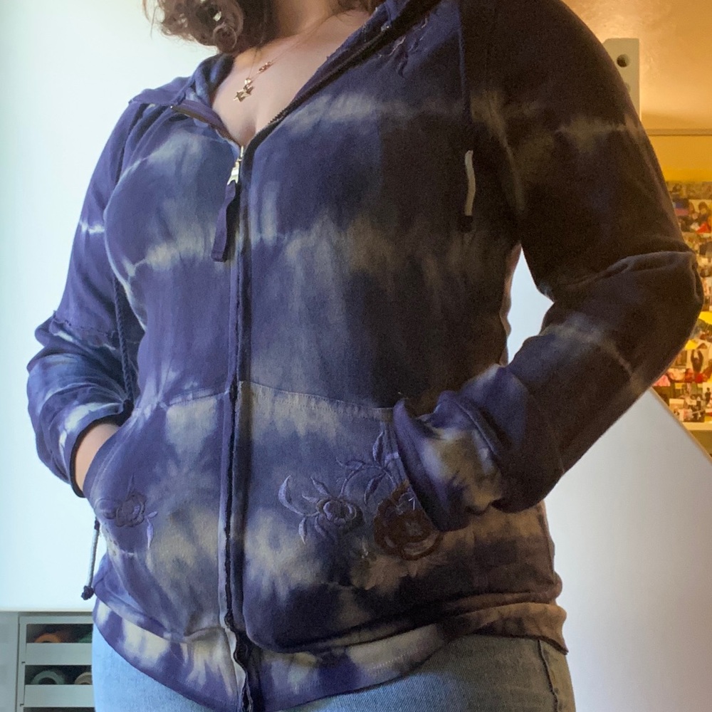 A tie-dye blue & white jacket with flower patches